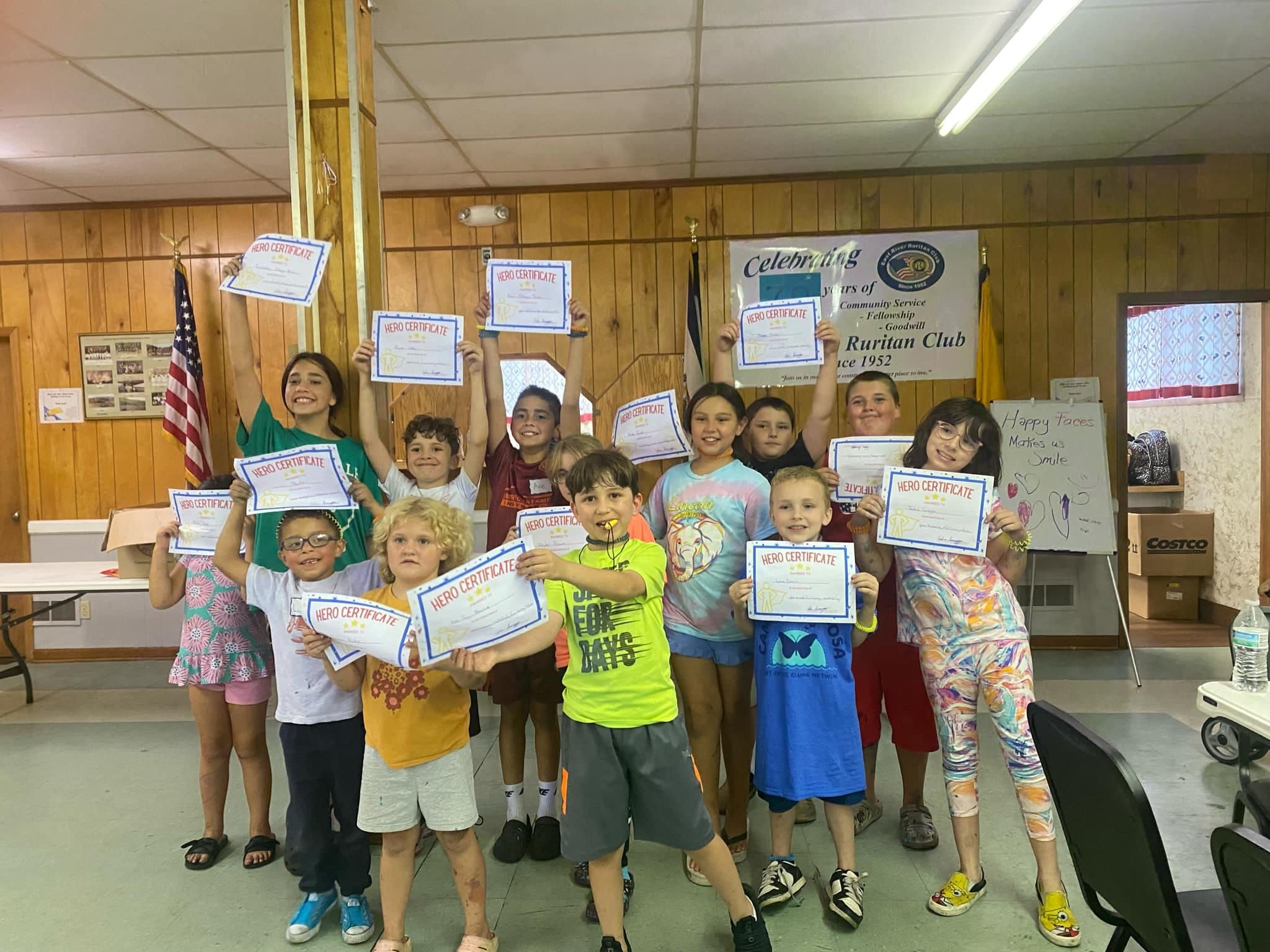 Young heroes participating in OAOT art and adventure programs